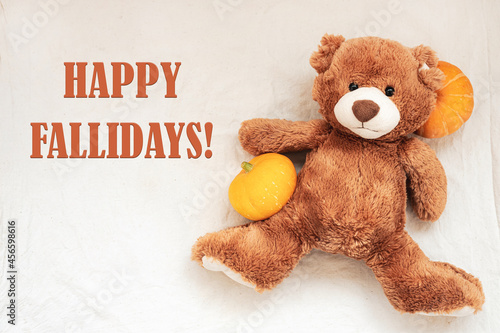 Quadro su tela Happy Fallidays, text with soft toy teddy bear and pumpkin on white sackcloth fabric texture, flat lay, top view