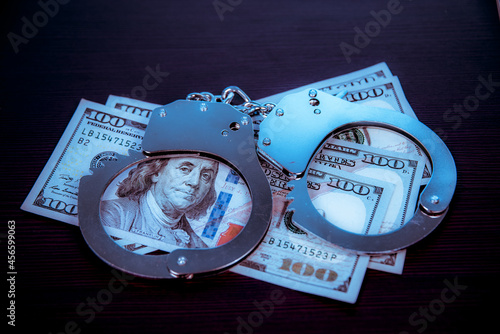 Dollars and police handcuffs. Crime.