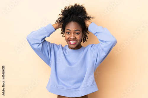 Young African American woman isolated on beige background doing nervous gesture