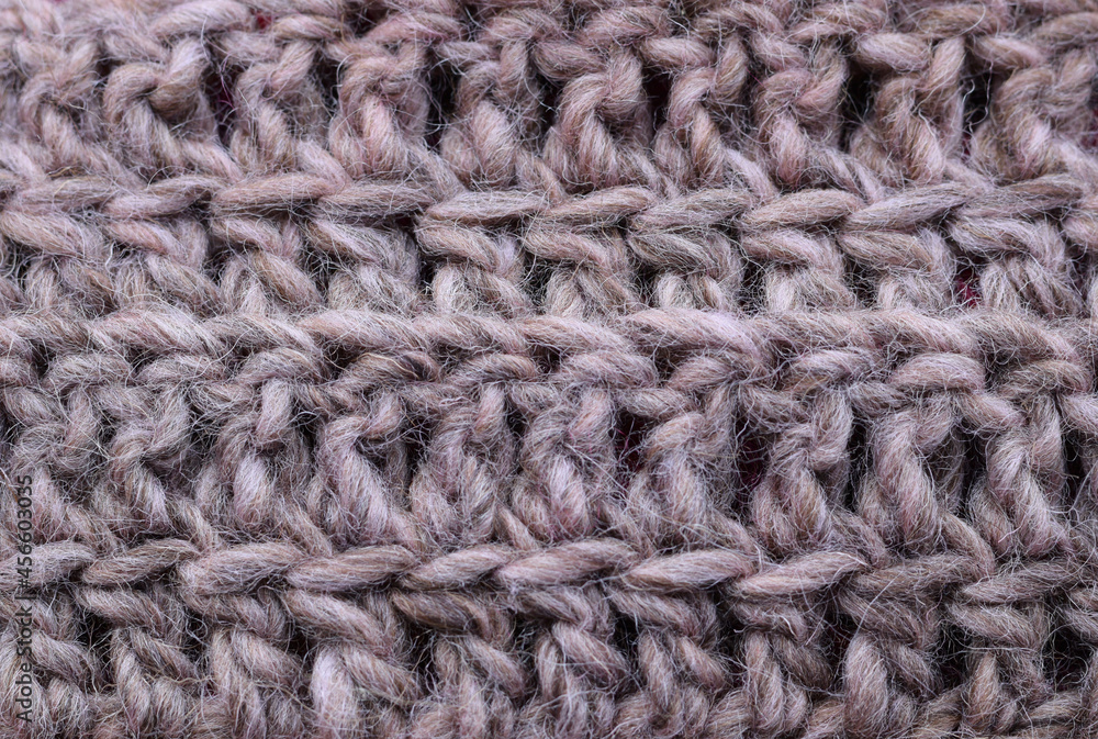 Close-up knitted wool texture in natural grey color.