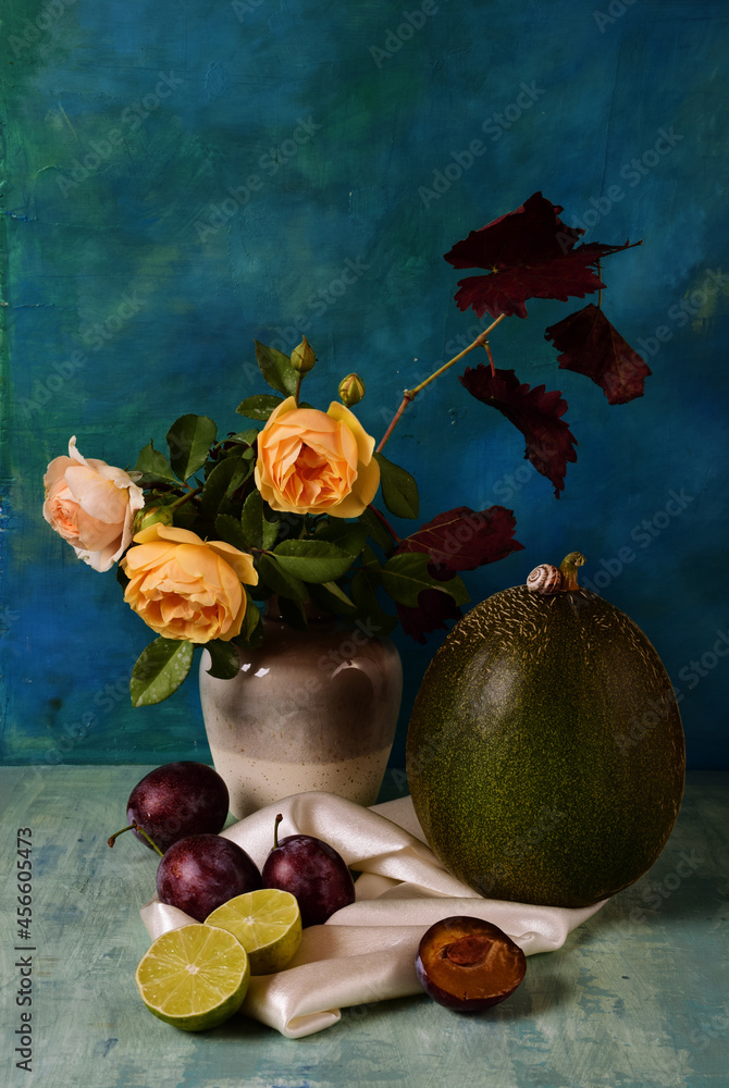 Still life of yellow roses, plums, limes and melons. Tinting