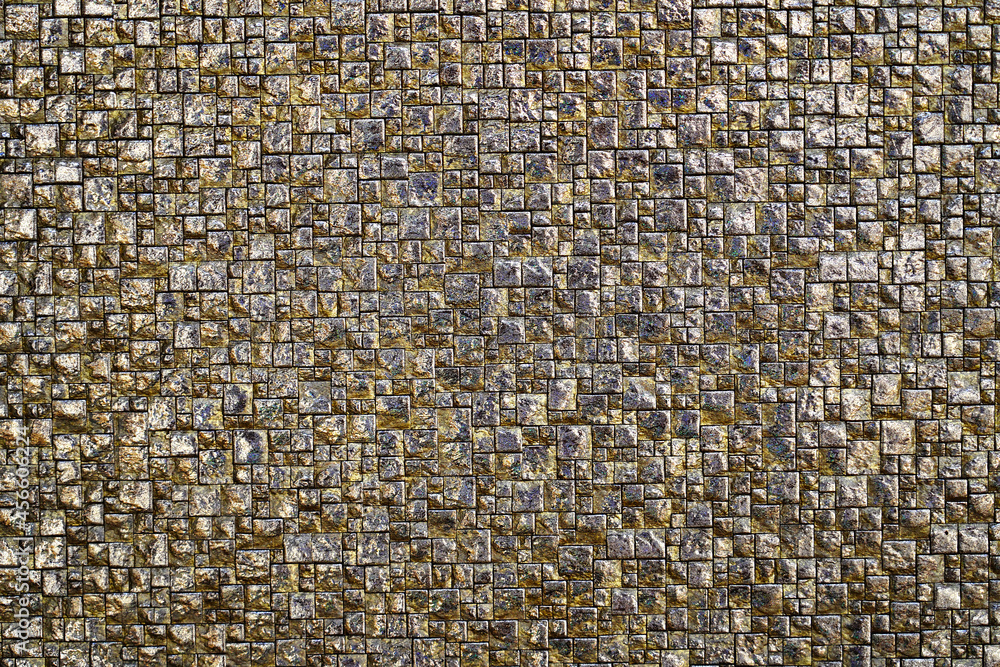 Fototapeta premium Brown grey wall of large and small squares, floor with cracks, texture background