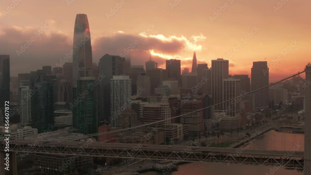 Aerial: Traffic on San Francisco Bay Bridge and city skyline at sunset Aerial: Traffic on San Francisco Bay Bridge and city skyline at sunset