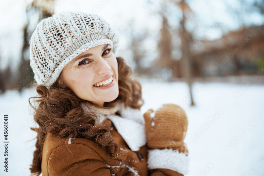 Portrait of happy stylish woman outside in city park in winter Portrait of happy stylish woman outside in city park in winter