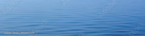 Blue ripples on the water surface, natural blue background for banner