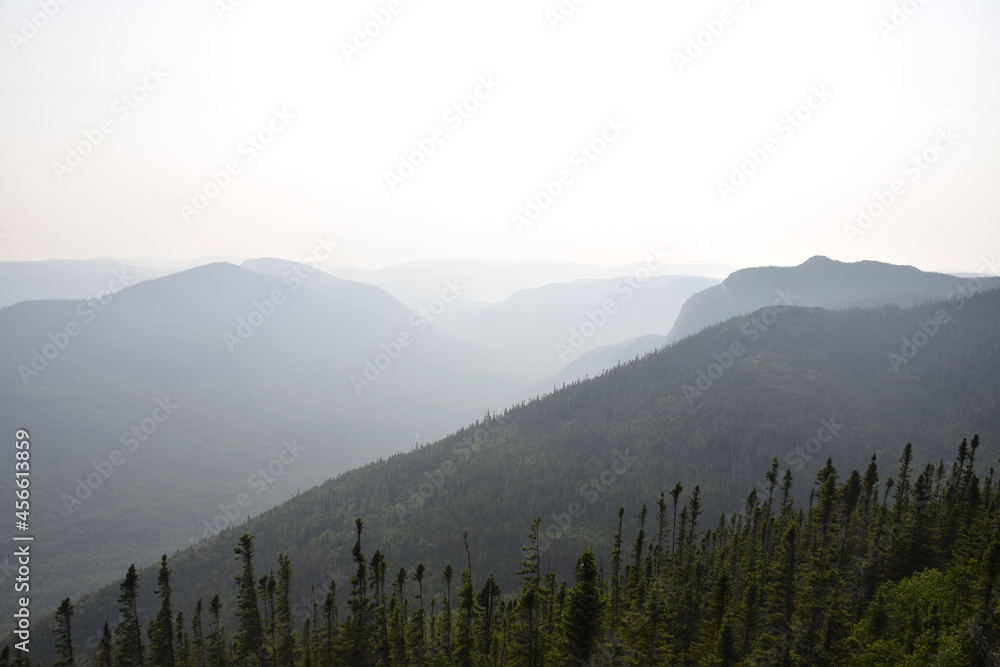 Mont des Morios, Quebec, Canada: View of the mountain outlines during a foggy muggy sunset