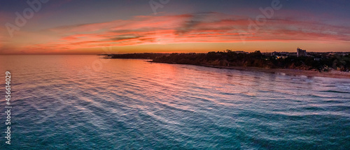 Aerial sunset seascape of Maria Luisa beach in Albufeira, Algarve destination region, Portugal.