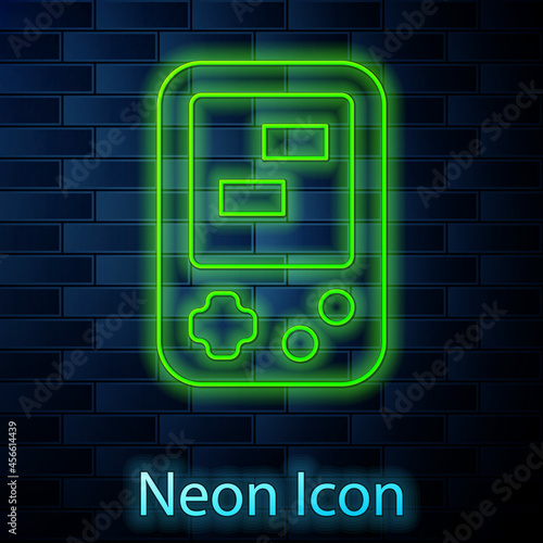 Glowing neon line Portable tetris electronic game icon isolated on brick wall background. Vintage style pocket brick game. Interactive playing device. Vector