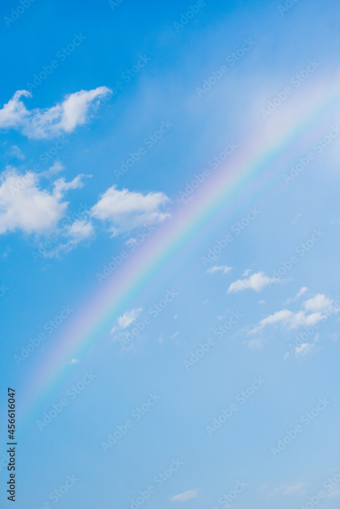 Beautiful Rainbow with blue sky behind and clouds after a thunderstorm