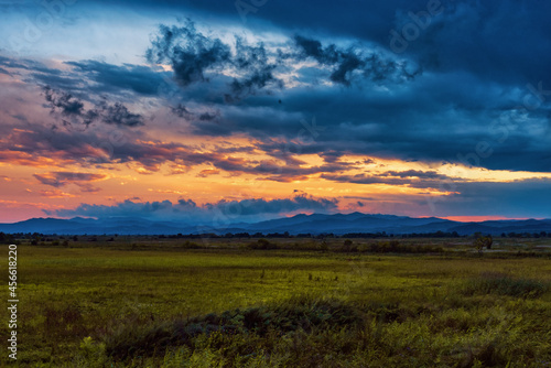 Colorful sunset over wide meadow