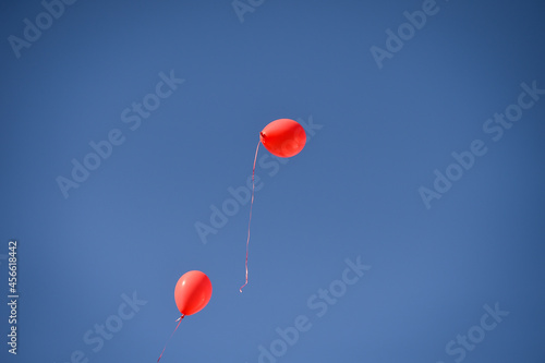 Red balloons, symbol of World Duchenne Awareness Day, are released into the blue open sky.