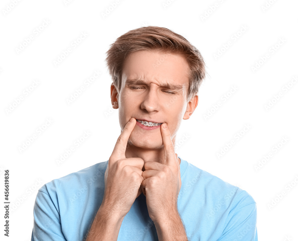 Handsome man with dental braces on white background Handsome man with dental braces on white background