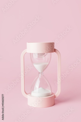 Stylish hourglass on pink background