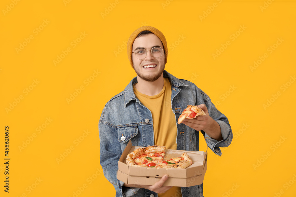Handsome young man with tasty pizza on color background Handsome young man with tasty pizza on color background