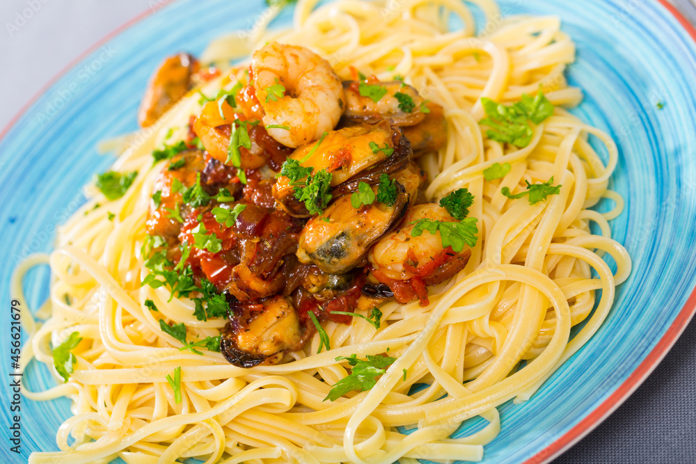 Delicious Italian seafood pasta with cocktail of mussels and prawns in vegetable sauce..