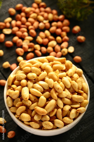 Delicious appetizer snack foods- baked ,salted peanuts served in ceramic bowl.