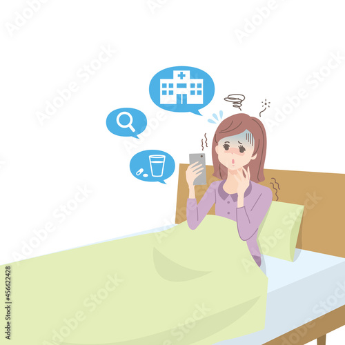 体調不良の女性がスマホで病院を探している様子