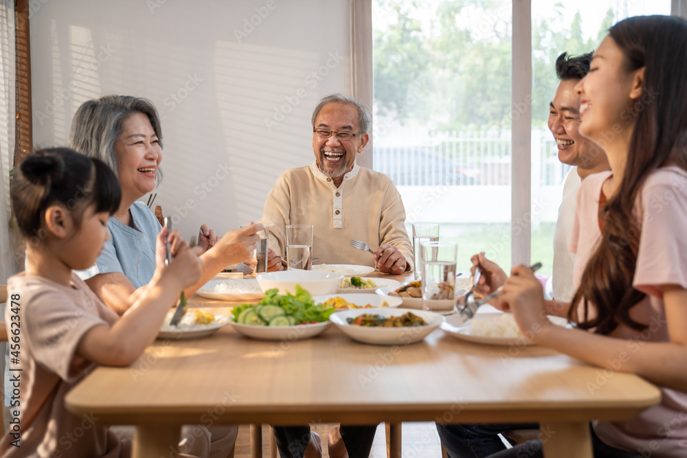 Asian Big happy family spend time have lunch on dinner table together. 