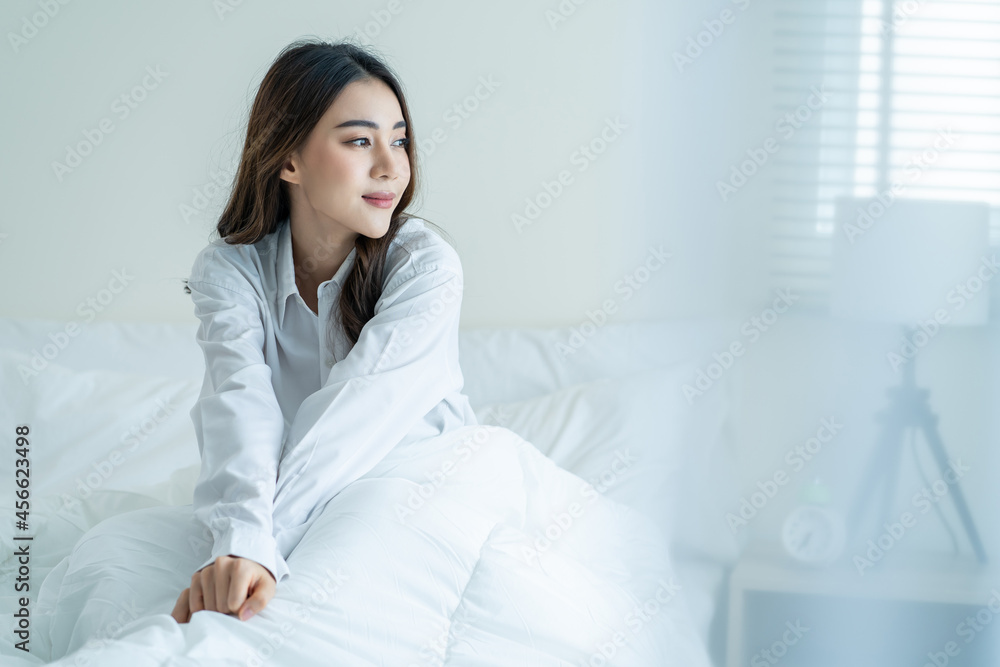 Asian beautiful girl in pajamas wake up in the morning with happiness. Asian beautiful girl in pajamas wake up in the morning with happiness.