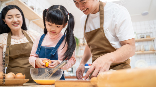 Asian happy family stay home in kitchen bake bakery and food with kid. 