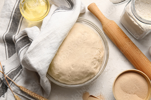 Composition with fresh dough and dry yeast on light background