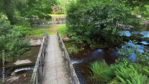 Water creek running under an old wooden bridge at Lunedet, Karlskoga - Sweden. photo