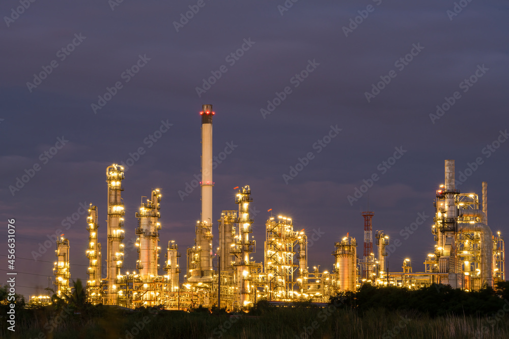 Lights in oil refinery industry factory power petroleum station show under working at night time with dark sky.