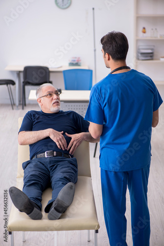 Old man visiting young male doctor