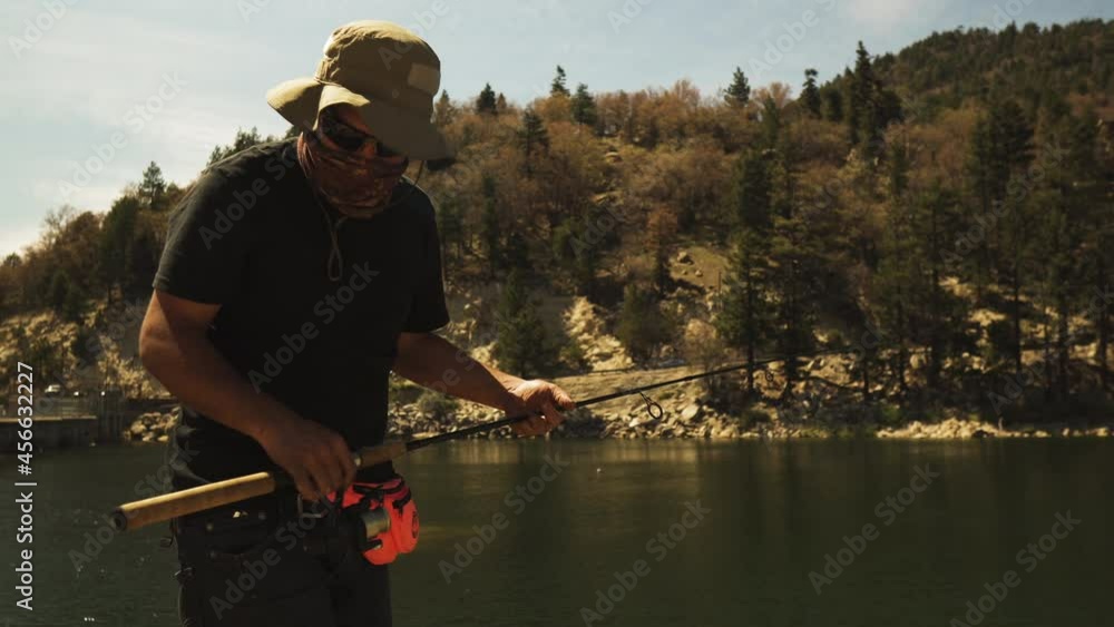 A fisherman fishes at a lake in California on a hot summer day, America A fisherman fishes at a lake in California on a hot summer day, America
