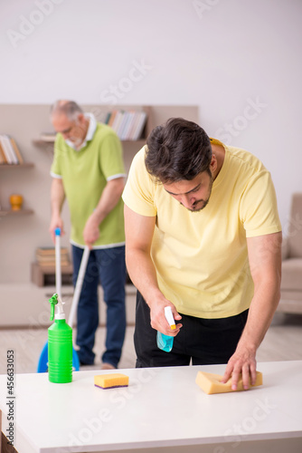 Two male contractors cleaning the house
