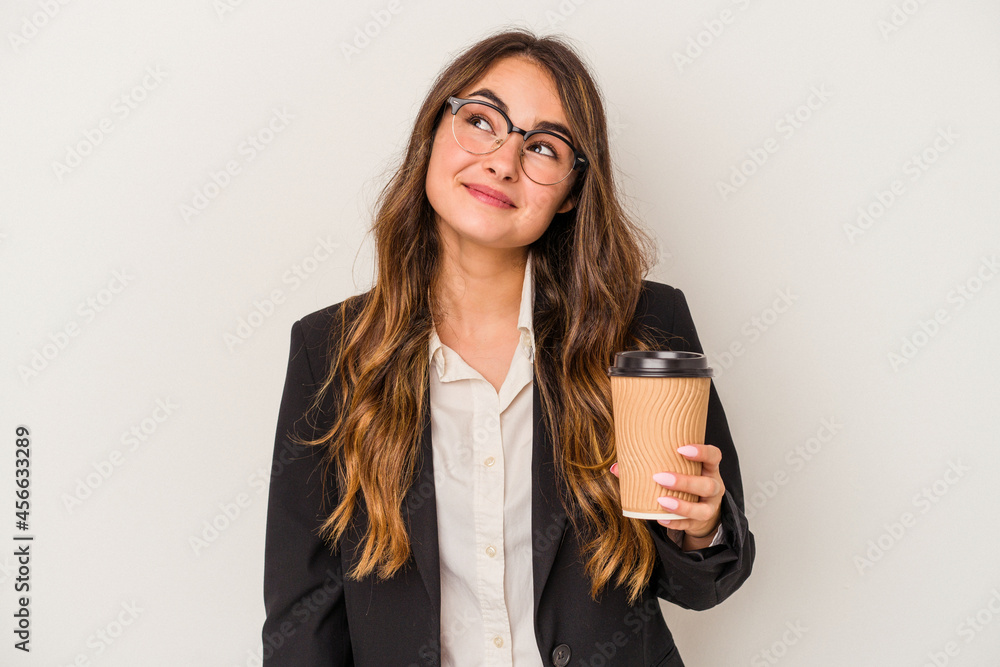 Young caucasian business woman holding a takeaway coffee isolated on white background dreaming of achieving goals and purposes Young caucasian business woman holding a takeaway coffee isolated on white background dreaming of achieving goals and purposes