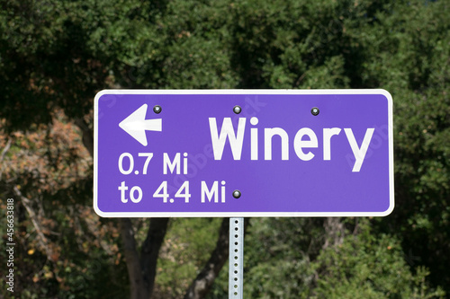 Winery road sign with arrow and distance in miles directs visitors to nearby wineries