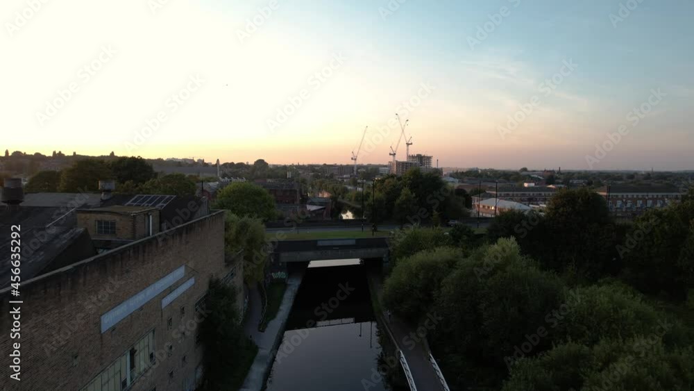 Ascending Aerial shot of a drone following along a canal, revealing the greater city on a beautiful morning, Birmingham, England Ascending Aerial shot of a drone following along a canal, revealing the greater city on a beautiful morning, Birmingham, England