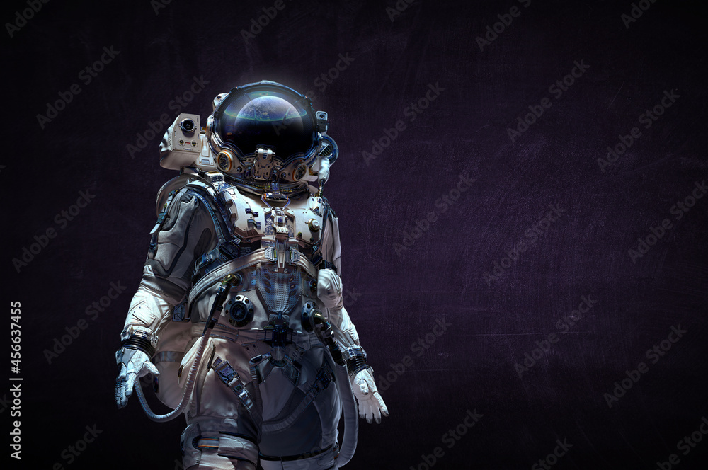 Fototapeta premium Astronaut in suit against black background. Space technology concept