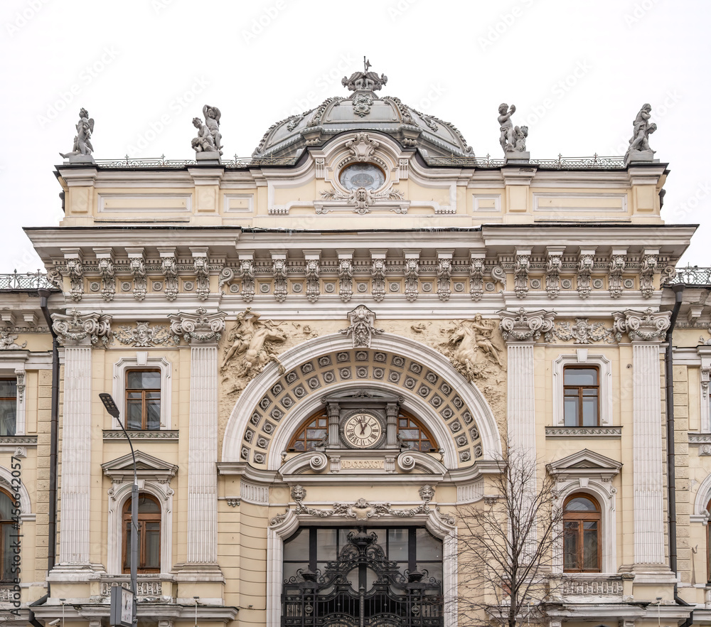 Luxurious building in the Baroque style, Firsanova's apartment house, Neglinnaya street 14, Moscow, Russia. Facade of a 18th century building with gate, clock and stucco decoration.