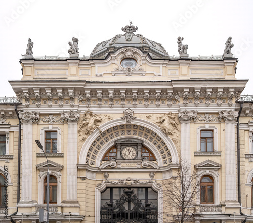 Luxurious building in the Baroque style  Firsanova s apartment house  Neglinnaya street 14  Moscow  Russia. Facade of a 18th century building with gate  clock and stucco decoration.