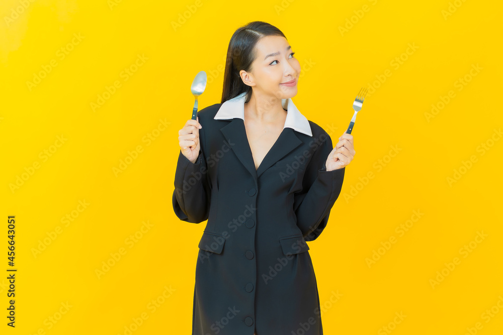 Portrait beautiful young asian woman smile with spoon and fork Portrait beautiful young asian woman smile with spoon and fork