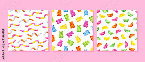 Jelly candy bears, worms, slices seamless patterns set. Bright gummy sweets. Vector cartoon illustration