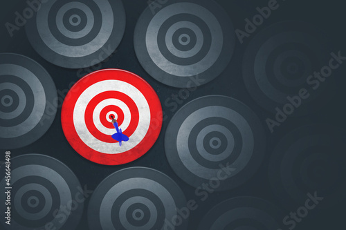 Blue dart among crowded empty dartboards