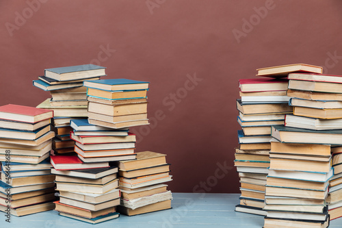 Stacks of books for teaching college library knowledge brown background