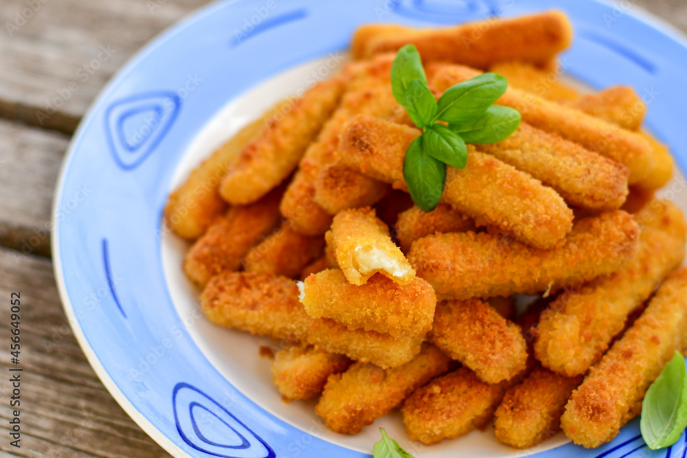 Crispy deep fried turkey nuggets and ketchup. Breaded turky efillets with chilly peppers and fresh basi on wooden rustic background
Crispy deep fried turkey nuggets and ketchup. Breaded turky efillets with chilly peppers and fresh basi on wooden rustic background