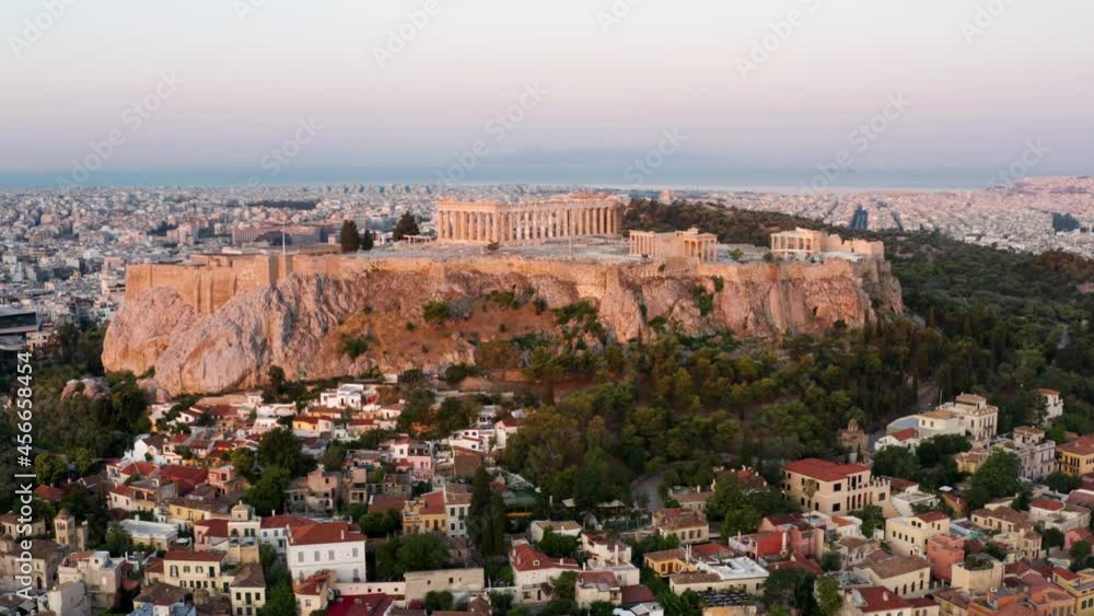 Early Morning View Of Historic Acropolis Ruins On Rocky Outcrop In Athens, Greece At Sunrise. aerial orbit Early Morning View Of Historic Acropolis Ruins On Rocky Outcrop In Athens, Greece At Sunrise. aerial orbit