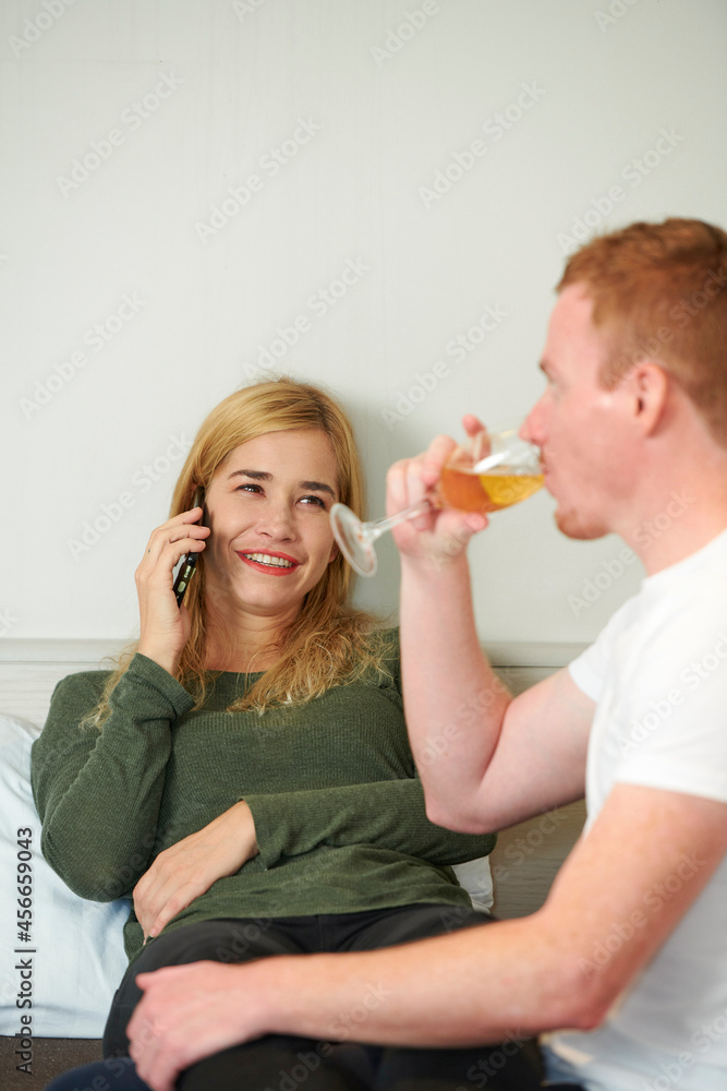 Cheerful young woman making phone call to order pizza for romantic dinner at home Cheerful young woman making phone call to order pizza for romantic dinner at home
