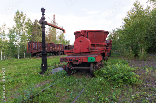 red trolley with a container on rails