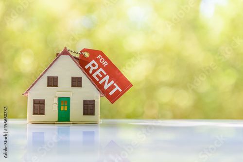 Принти на полотні House for rent concept : Model house and a paper tag with chain, depicts a payment for temporary use of a property owned by another owner, tenant unwilling to pay full price, avoid burden of upkeep