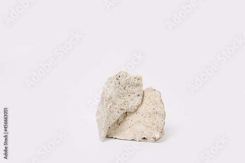 Stone podium for products, cosmetics, cream or perfumes on white background.