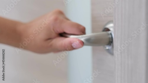 close up woman hand opening door in bedroom