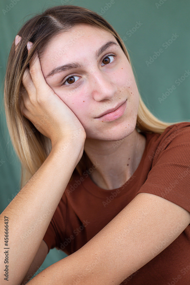 Portrait woman with hand near the face isolated on green Portrait woman with hand near the face isolated on green