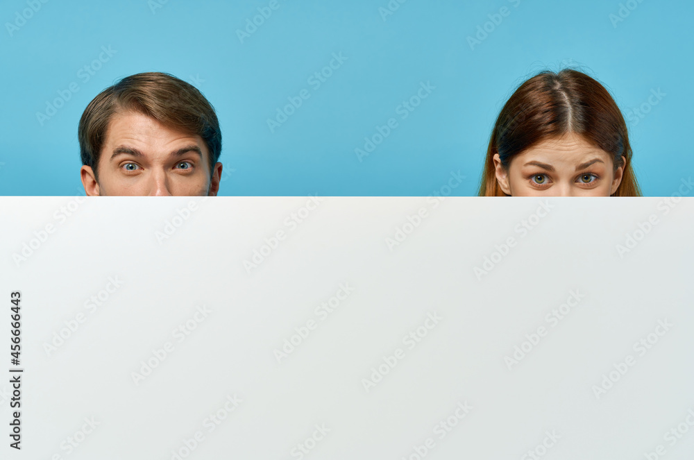 Man and woman with white mockup poster advertising sign isolated background Man and woman with white mockup poster advertising sign isolated background