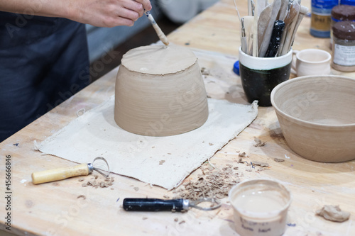 craftsman makes a clay pot in a workshop